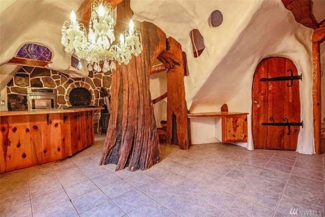 The interior of the first floor shows a stone oven, a fake tree, and a chandelier.