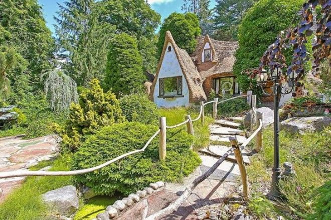 An exterior view of the cottage through an overgrown garden.