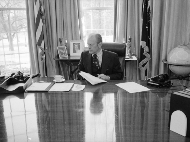 Even though this photo was taken as Gerald Ford prepared to vacate the White House, his desk still featured several stacks of papers, as well as a cup and saucer.