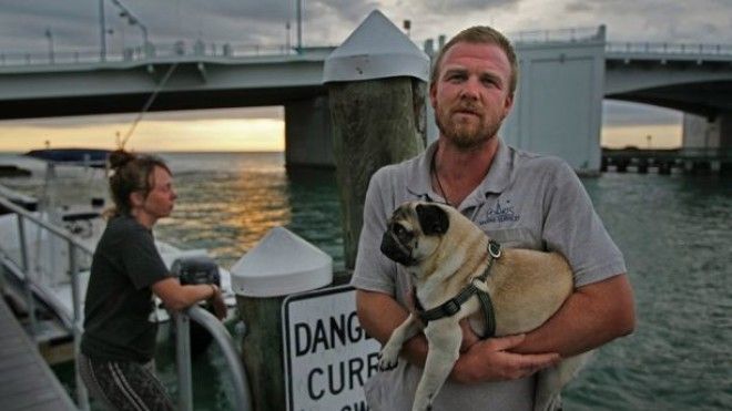 February 8, 2018 - Madiera Beach, Florida, U.S. - JIM DAMASKE | Times.Tanner Broadwell, 26, and Nikki Walsh, 24, sold everything they had in Colorado, bought an old sailboat and set out to sail around the Caribbean with their 2-year-old Pug, Remy. But their trip was cut short on Wednesday night when motoring their boat named Lagniappe into John's Pass (background), they struck something underwater that tore their boat's keel off and caused it to sink about 20 minutes later. They and their dog were rescued, but are now stranded in Madeira Beach with one cell phone some of her clothes and some dog food. (Credit Image: Â© Jim Damaske/Tampa Bay Times via ZUMA Wire)