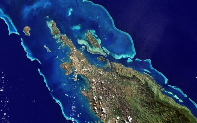 Here's a natural color image of one of the islands of New Caledonia, a remote archipelago 750 miles off the coast of Australia. The paler blue is shallower water, while the dark blue is the deep sea.