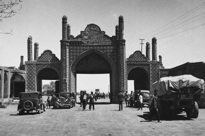 One of the last remaining gates of Tehran frame a bustling street scene.